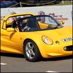Yellow Lotus Elise W789RRJ at the Silverstone Classic 2013
